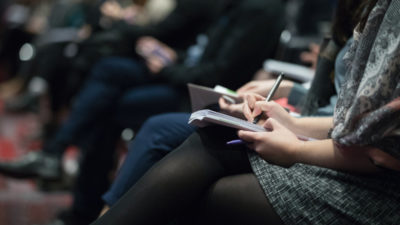 A journalist taking notes at VS Pack exhibition in Cognac